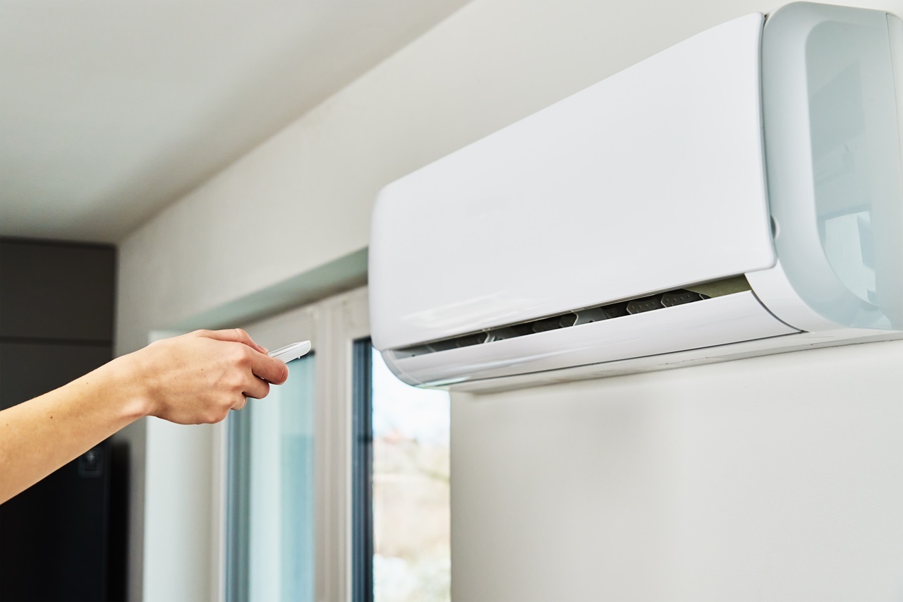 hand adjusting temperature on air conditioner 2023 11 27 05 15 31 utc